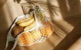 Creative summer food still life with bananas, coconut, oranges and lemons.