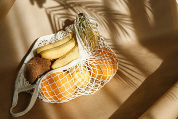 Creative summer food still life with bananas, coconut, oranges and lemons.