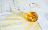 Flask and test tubes with urine on medical color schemes. Concept of analyzes