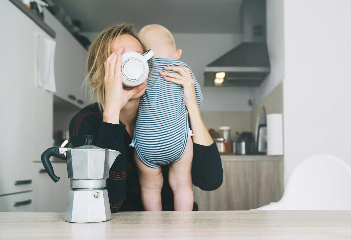 Modern tired mother and little child after sleepless night. Postpartum depression