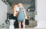 Modern tired mother and little child after sleepless night. Postpartum depression