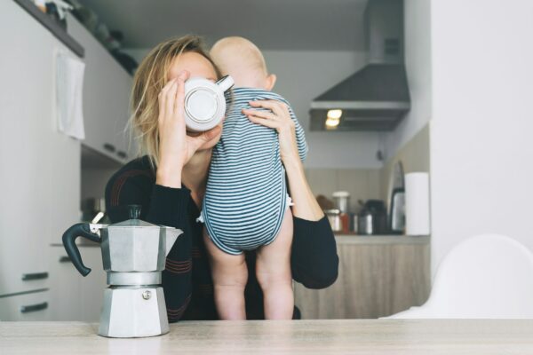 Modern tired mother and little child after sleepless night. Postpartum depression