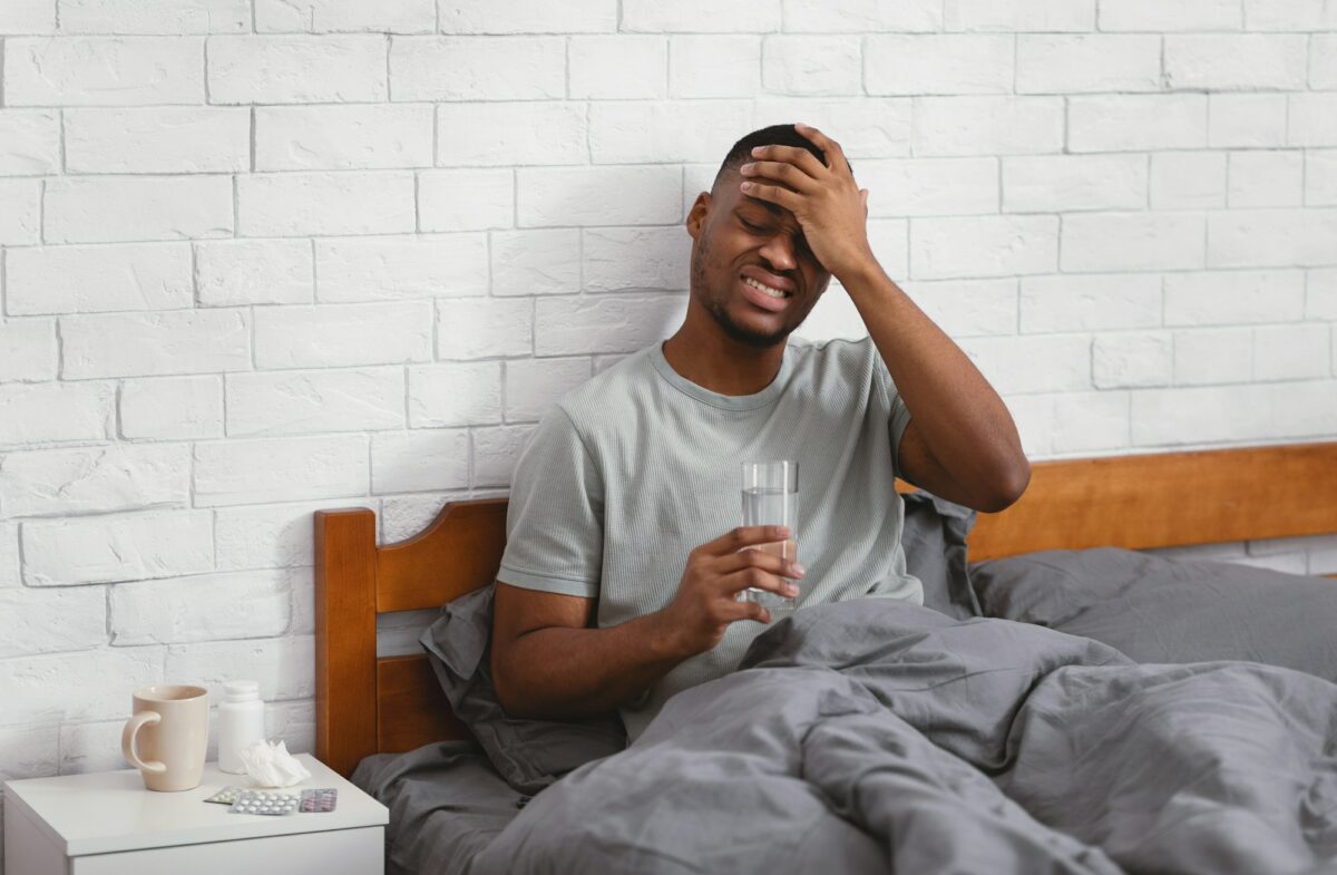 Sick Black Man Having Fever During Influenza Illness In Bedroom