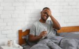 Sick Black Man Having Fever During Influenza Illness In Bedroom