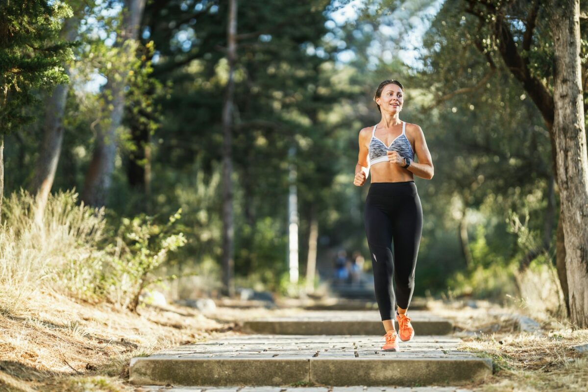 Woman Running In Park At Summer Day