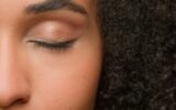 Beauty female portrait half of face close up eye beautiful make-up arrow eyelashes eyeliner eyelid