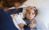 Boy measuring fever