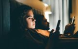 Couple with smartphones in their bed. Mobile phone addiction.
