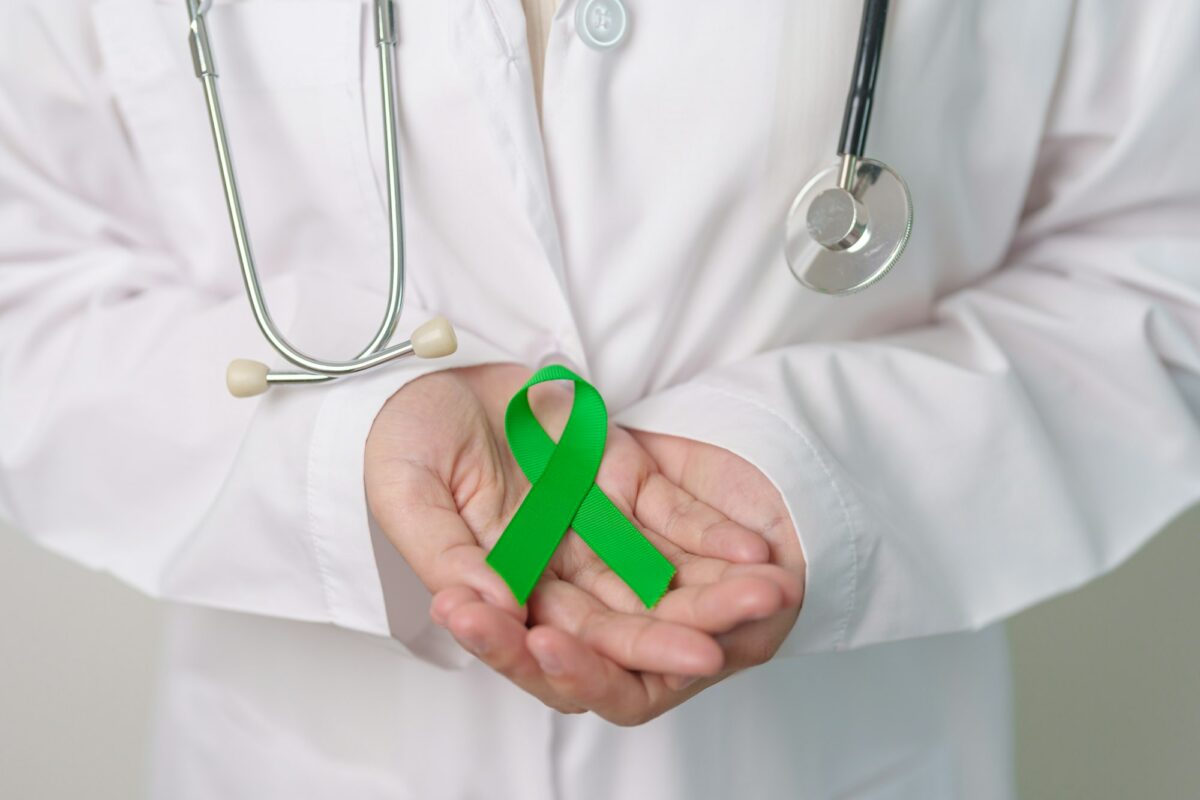 Doctor with green Ribbon for world Mental Health Day
