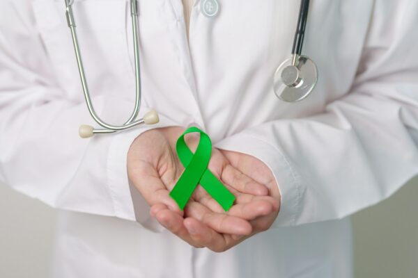 Doctor with green Ribbon for world Mental Health Day