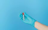 Hand holding test tube with the inscription anemia