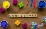 Montessori on wooden alphabet concept with toys on wooden background.