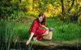 Nature Impact Wellbeing. Woman in red dress enjoying nature.