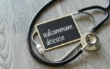 Stethoscope and chalkboard with text AUTOIMMUNE DISEASE
