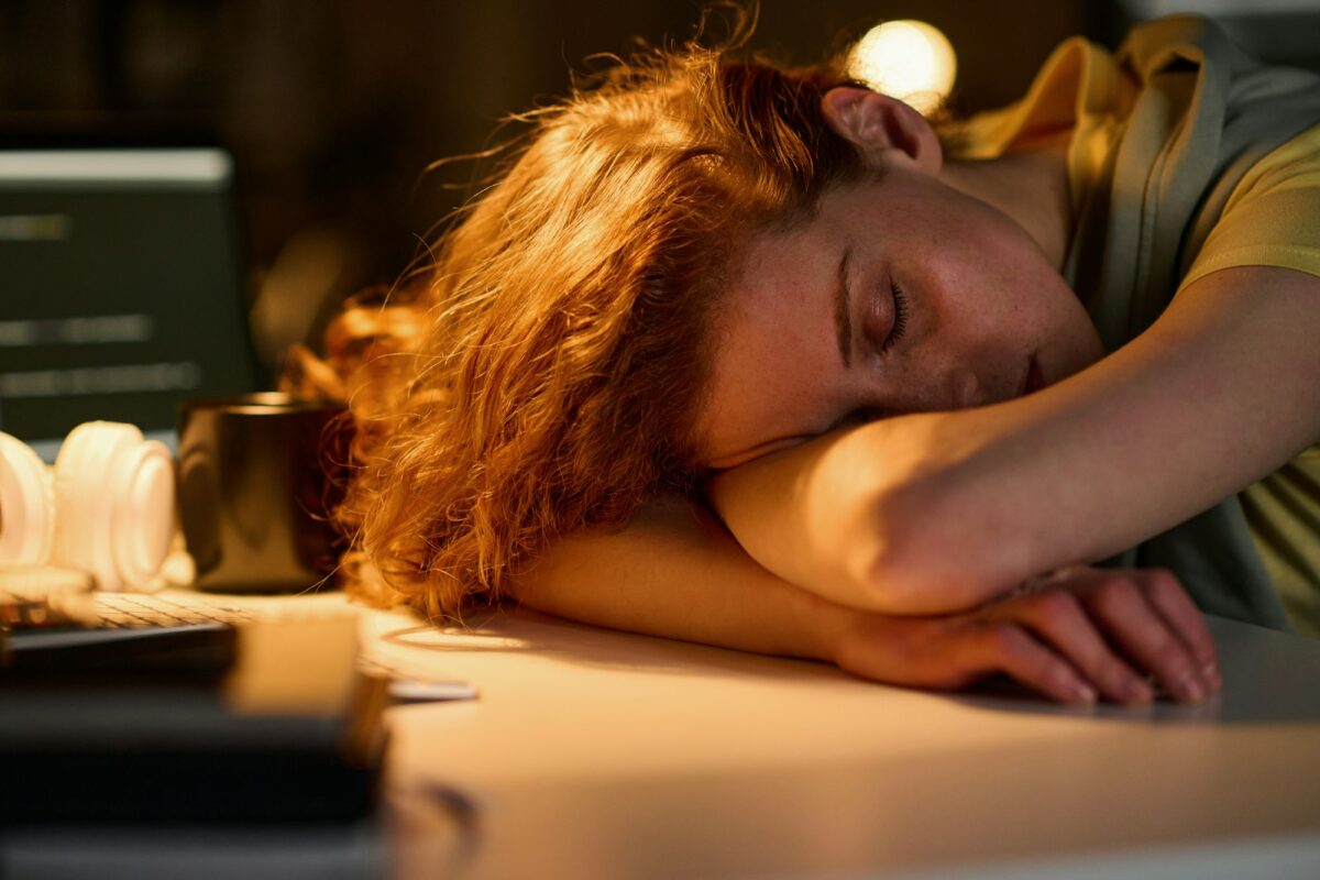 Tired woman sleeping at her workplace