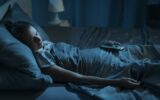 Woman sleeping with her TV on