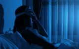 Young woman with a headache and insomnia