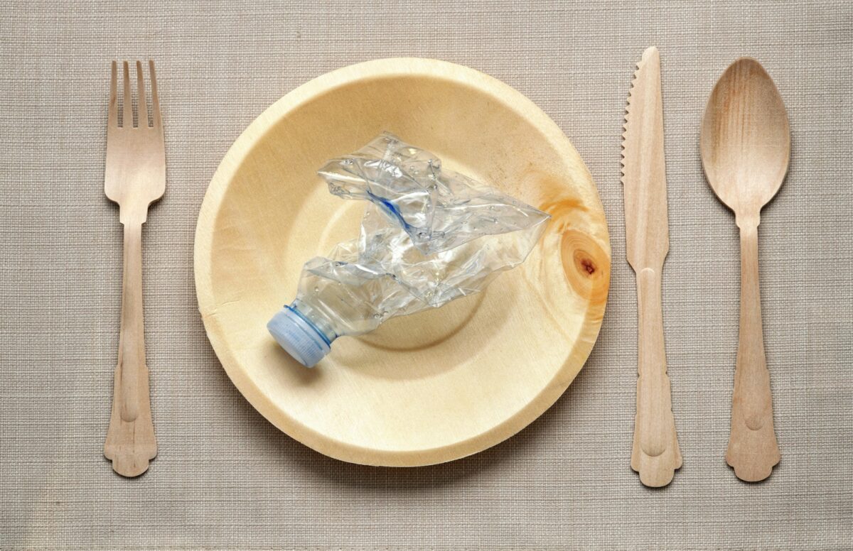 Eating plastic concept with table setting
