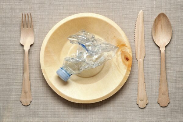 Eating plastic concept with table setting