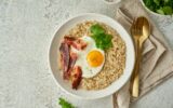 Oatmeal, fried egg, fried bacon. Balanced food. Intuitive conscious food, top view, copy space