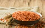 Red raw lentils in a bowl. The concept of vegetable protein.
