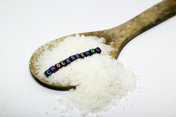 sugar in a puff with the word cholesterol.