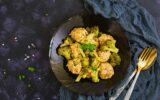 Chicken meatballs with broccoli on dark background