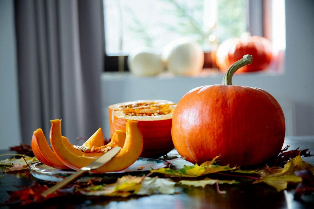cut pumpkin on a plate with cutlery on the table