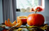 cut pumpkin on a plate with cutlery on the table