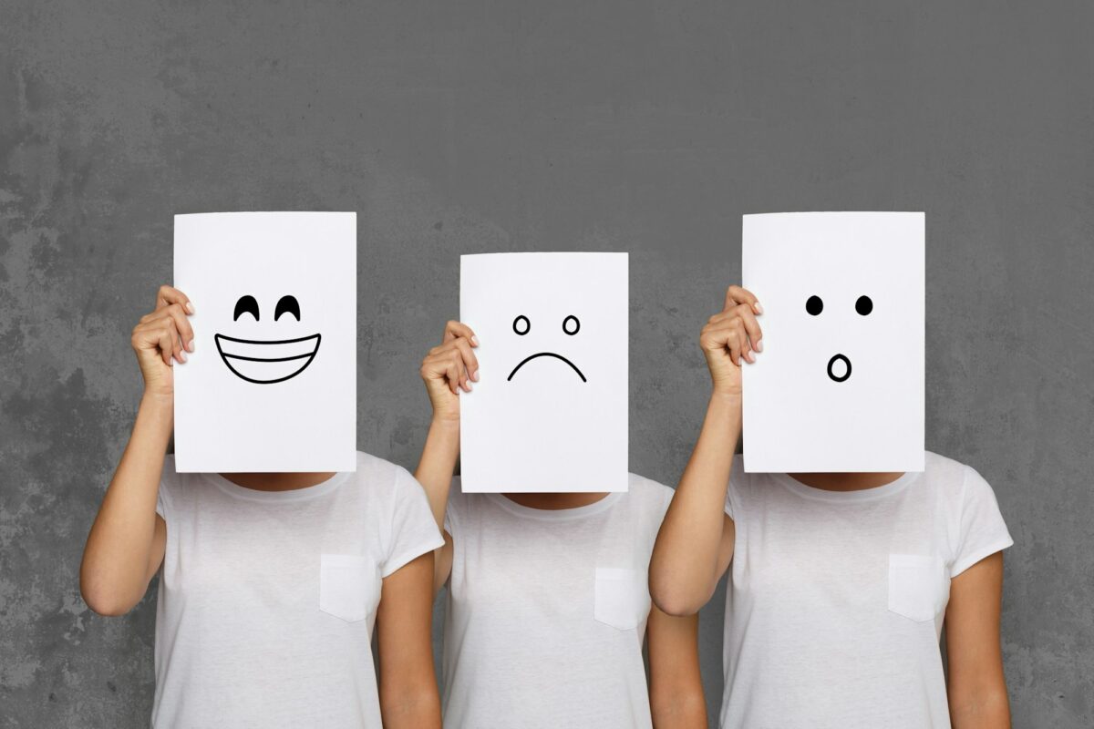 Girl covering face with white boards. Set of painted emotions