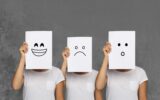 Girl covering face with white boards. Set of painted emotions