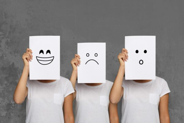 Girl covering face with white boards. Set of painted emotions