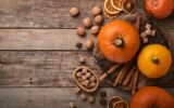 Pumpkin. Autumn food background with cinnamon, nuts and seasonal spices on rustic background. Cookin