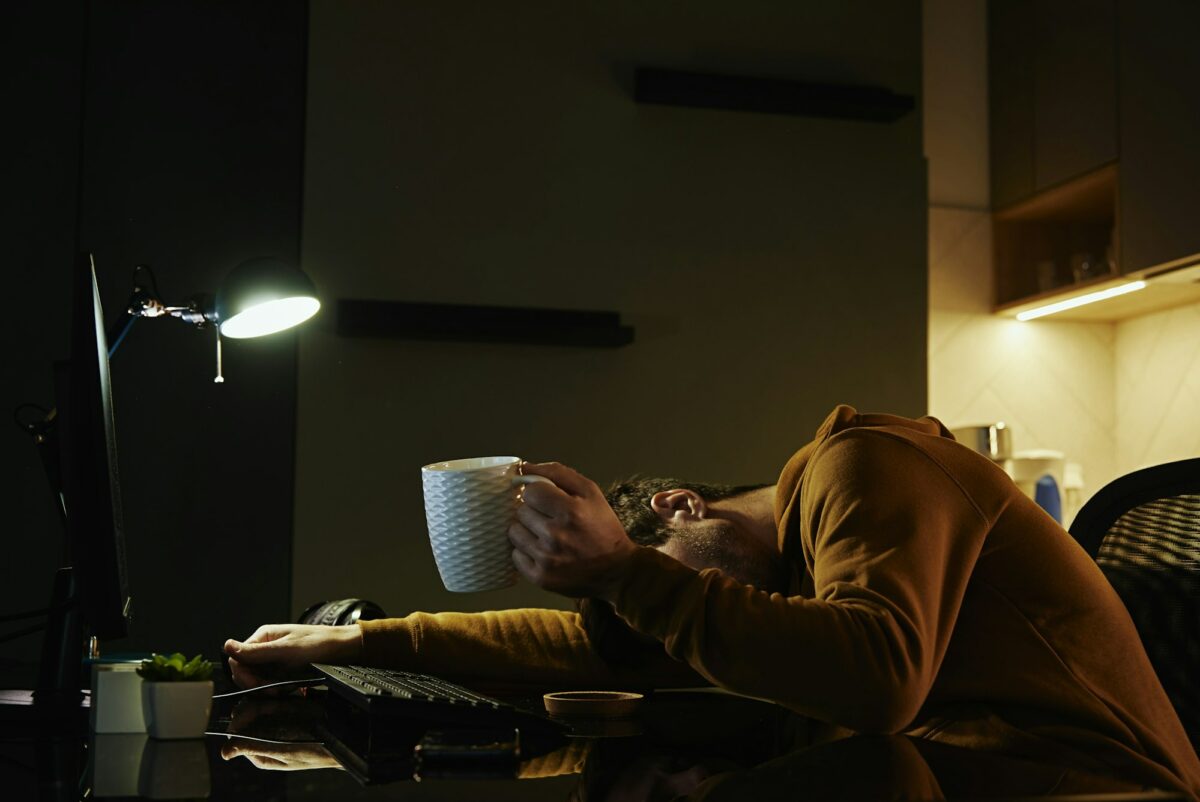 Tired man sleeping at workplace