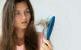 Young woman is upset because of hair loss