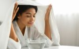 Beauty Hacks. Young black woman inhaling steam of hot water at home