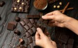 Closeup male hands breaking a bar of chocolate