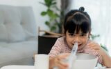 Little asian girl saline nasal wash nose at home.