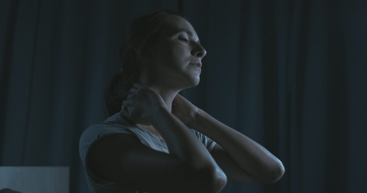 Tired woman massaging her neck