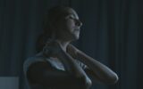 Tired woman massaging her neck