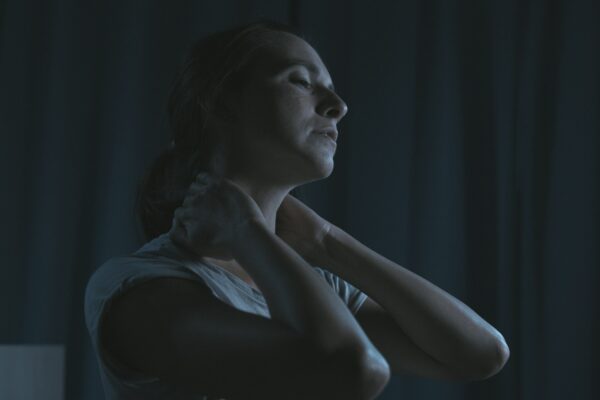 Tired woman massaging her neck