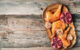 Traditional Thanksgiving day celebration party. Roasted chicken with pomegranate and garlic on