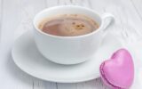 A cup of hot chocolate with a heart-shaped macaron
