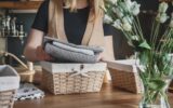 Girl spring cleaning in the kitchen. Piles kitchen towels in baskets. Spring cleaning, decluttering