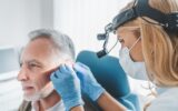 Mature patient with hearing problem visiting doctor otolaryngologist