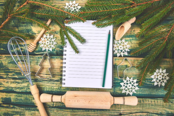 Christmas menu plan or recipe on green rustic wooden background