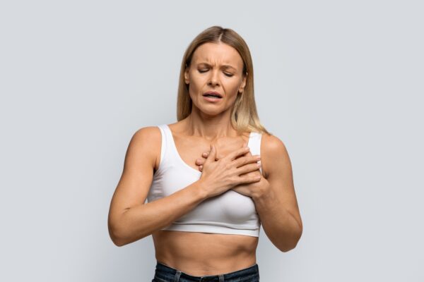 Middle aged woman suffering from severe chest pain