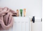 Radiator with thermostat and euro money banknotes.