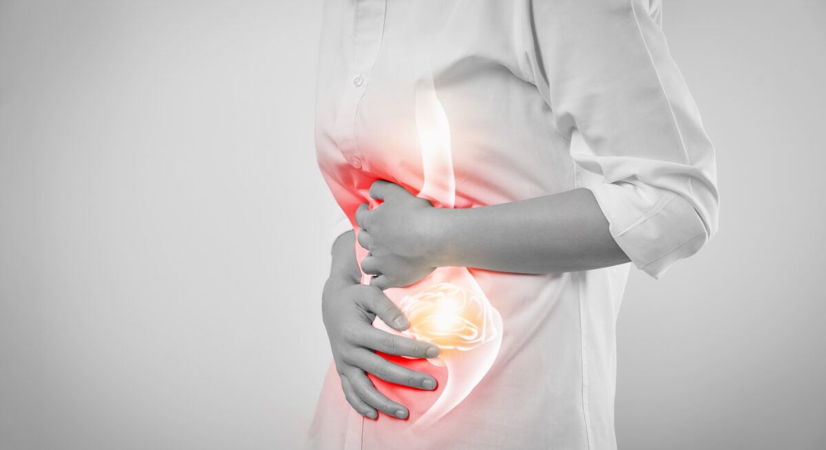 Woman hands touching belly and stomach painful suffering from chronic gastritis on white background.