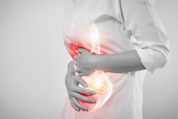 Woman hands touching belly and stomach painful suffering from chronic gastritis on white background.